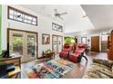 Bright living room with vaulted ceilings, skylights, brick floors, and sliding door access to the deck at 131 Cypress St, Roswell, GA 30075