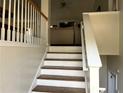 Interior view of the staircase leading upstairs, showcasing the railing and natural light at 1380 Cedar Hl, Douglasville, GA 30134