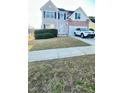 Charming two-story home with a well-manicured lawn and a white SUV parked in the driveway at 771 Franklin Mill Trce, Loganville, GA 30052