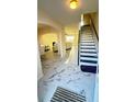 Welcoming foyer with stairs and an archway leading to a spacious living area with modern finishes at 771 Franklin Mill Trce, Loganville, GA 30052