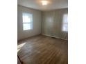 Bedroom with wood-look paneling, hardwood floors, and natural light from the windows at 1253 Gus Thornhill Jr Dr, Atlanta, GA 30344