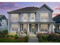 Beautiful home with a covered front porch, offering a cozy outdoor seating area at 9893 Colchester St, Douglasville, GA 30135
