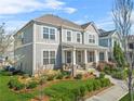 Beautifully landscaped two-story home with a welcoming front porch and a well-manicured lawn at 9893 Colchester St, Douglasville, GA 30135