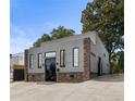 Contemporary home featuring gray siding, stone accents, and black framed windows at 175 Moreland Se Ave, Atlanta, GA 30316
