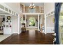 Grand foyer showcasing a soaring ceiling, hardwood floors, staircase, and natural light streaming through a large window at 3060 Birchton St, Johns Creek, GA 30022