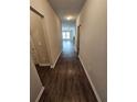 Hallway with neutral paint leads to a living room with ceiling fan and a fireplace at 333 Darlington Dr, Ellenwood, GA 30294