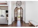 Bright entryway with dark wood floors, arched double doors, and a view of the living room at 425 Prestwick Ct, Alpharetta, GA 30005