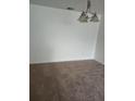 Bright living room featuring neutral carpet and a modern, three-bulb light fixture at 10303 Waldrop Place, Decatur, GA 30034