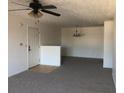 Spacious living room with carpet, ceiling fan, and a dining area with modern chandelier at 10303 Waldrop Place, Decatur, GA 30034