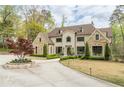 Beautiful stone and stucco home with meticulously landscaped front yard and circular driveway at 3451 Paces Ferry Nw Rd, Atlanta, GA 30327