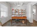 Bright home office featuring custom shelving, coffered ceilings, wood-look floors and plenty of natural light at 4025 Bullock Bridge Rd, Loganville, GA 30052
