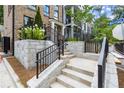 Stone staircase leading to a modern townhouse with black railings and manicured landscaping at 1770 Beckham Ne Pl # 47, Atlanta, GA 30324