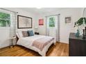 Comfortable bedroom featuring hardwood floors, two windows, and neutral decor at 679 Forest Ridge Se Dr, Marietta, GA 30067