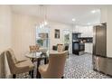 Eat-in kitchen with patterned tile floor, stainless steel appliances, and a modern light fixture at 679 Forest Ridge Se Dr, Marietta, GA 30067