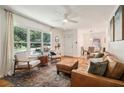 Cozy living room with natural light, stylish seating, and a decorative area rug over hardwood floors at 679 Forest Ridge Se Dr, Marietta, GA 30067