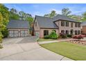 Brick home with an attached three-car garage and landscaped front yard at 3646 Sope Creek Farm Se, Marietta, GA 30067