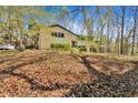 Charming two-story home featuring a lush front yard, complemented by mature trees, enhancing its curb appeal at 481 Patillo Rd, Stockbridge, GA 30281