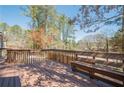 Spacious wooden deck with built-in bench seating, perfect for outdoor entertaining at 524 S Holly Springs Rd, Woodstock, GA 30188