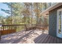 Spacious wooden deck with built-in bench seating and lots of shade from nearby trees at 524 S Holly Springs Rd, Woodstock, GA 30188