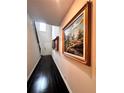 Bright entryway with hardwood floors, beautiful art, and a staircase leading to the upper level at 3049 Morgan Spring Trl, Buford, GA 30519