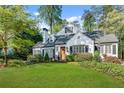 Inviting home exterior featuring a lush green lawn and mature trees, creating a picturesque curb appeal at 4000 N Stratford Ne Rd, Atlanta, GA 30342