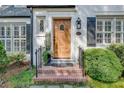 Beautiful entryway showcasing a wood door, brick steps, and manicured shrubs enhancing the home's curb appeal at 4000 N Stratford Ne Rd, Atlanta, GA 30342