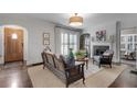 Bright living room with hardwood floors, a fireplace, and large window offering a comfortable space at 4000 N Stratford Ne Rd, Atlanta, GA 30342