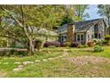 Landscaped front yard with stone walkway leading to a charming home with a stone chimney at 4183 Oak Crest Dr, Tucker, GA 30084