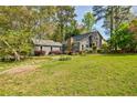 Charming home with a well-manicured lawn, stone chimney, and beautiful landscaping at 4183 Oak Crest Dr, Tucker, GA 30084