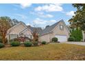 Beautiful home featuring a brick facade, manicured lawn, and an attached two-car garage at 777 Glen Valley Way, Dacula, GA 30019