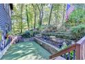Backyard with terraced landscaping, retaining walls, and artificial turf at 8530 Hightower Trl, Snellville, GA 30039