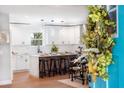 Modern kitchen featuring white cabinetry, a center island with barstool seating, and designer pendant lighting at 5747 S Gordon Rd, Austell, GA 30168