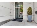 Building entrance with address, glass doors, a modern exterior, and professional landscaping near the entrance at 1100 Howell Mill Nw Rd # 711, Atlanta, GA 30318