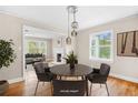 Dining area open to the living room, features hardwood floors, and modern lighting at 1910 Thompson Ave, East Point, GA 30344