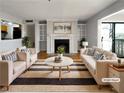 Bright living room with fireplace, built-in shelving, and access to a balcony with a view at 4640 Vinings Central Se Run # 128, Atlanta, GA 30339