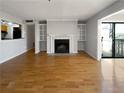 Spacious living room features hardwood floors, a fireplace, and balcony access at 4640 Vinings Central Se Run # 128, Atlanta, GA 30339
