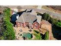Aerial view showcasing a home's backyard oasis with a pool, patio, and well-maintained landscaping at 4777 Ardmore Ln, Hoschton, GA 30548