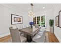 Elegant dining room with a modern chandelier, hardwood floors, and a large window at 53 Paces West Nw Dr, Atlanta, GA 30327