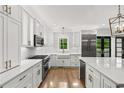 Modern kitchen with white cabinetry, stainless steel appliances, and a large island at 53 Paces West Nw Dr, Atlanta, GA 30327
