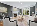 Bright living room features a fireplace, large window, and neutral decor at 53 Paces West Nw Dr, Atlanta, GA 30327