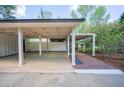 Spacious carport features ample parking with a brick walkway leading to the entrance at 541 Earlvine Nw Way, Kennesaw, GA 30152