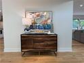 Inviting entryway featuring a wood console table, modern lamp, and colorful painting at 541 Earlvine Nw Way, Kennesaw, GA 30152