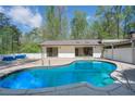 Inviting backyard pool with patio and modern design of home visible in the background at 541 Earlvine Nw Way, Kennesaw, GA 30152