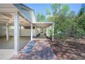 Covered walkway featuring brick pavers, black rock, and a serene backyard view at 541 Earlvine Nw Way, Kennesaw, GA 30152