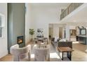 Bright living room with a fireplace, high ceilings, modern decor, and hardwood floors at 2198 Oakawana Ne Dr, Atlanta, GA 30345