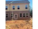 Townhome backyard featuring a brick facade, multiple windows, and a back door at 3108 Marbella Cir # 4, Kennesaw, GA 30152