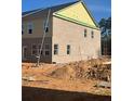 Exterior side view of a new home with a brick facade and unfinished landscaping at 3108 Marbella Cir # 4, Kennesaw, GA 30152