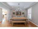 Charming dining room with hardwood floors, chandelier, and bright, neutral decor at 622 Goldpoint Trce, Woodstock, GA 30189