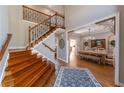 Grand foyer featuring hardwood floors, staircase with iron spindles, and formal dining room entrance at 622 Goldpoint Trce, Woodstock, GA 30189