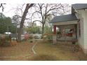 Side yard featuring a well, patio, and lush greenery, perfect for outdoor relaxation and enjoyment at 1130 Ridge Ave, Stone Mountain, GA 30083